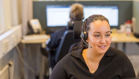 A girl wearing a headset in a call-center.